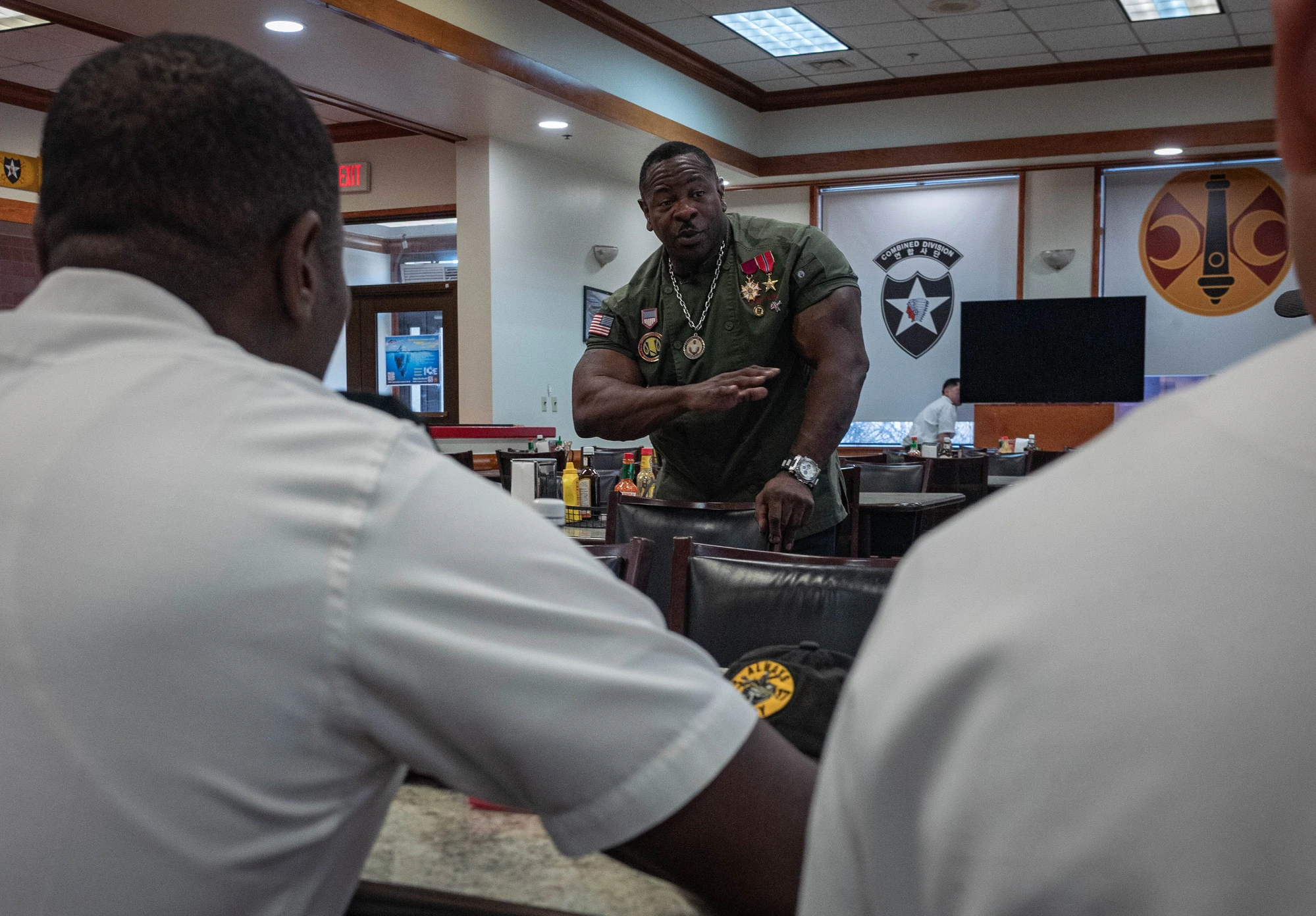Chef Rush speaking with military cooks in a dining facility